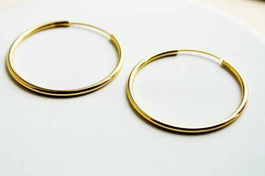18K Gold Plain Endless Hoops Discover 18K Gold Plain Endless Hoops: Simple, Everyday, Minimalist Geometric Earrings for Effortless Style