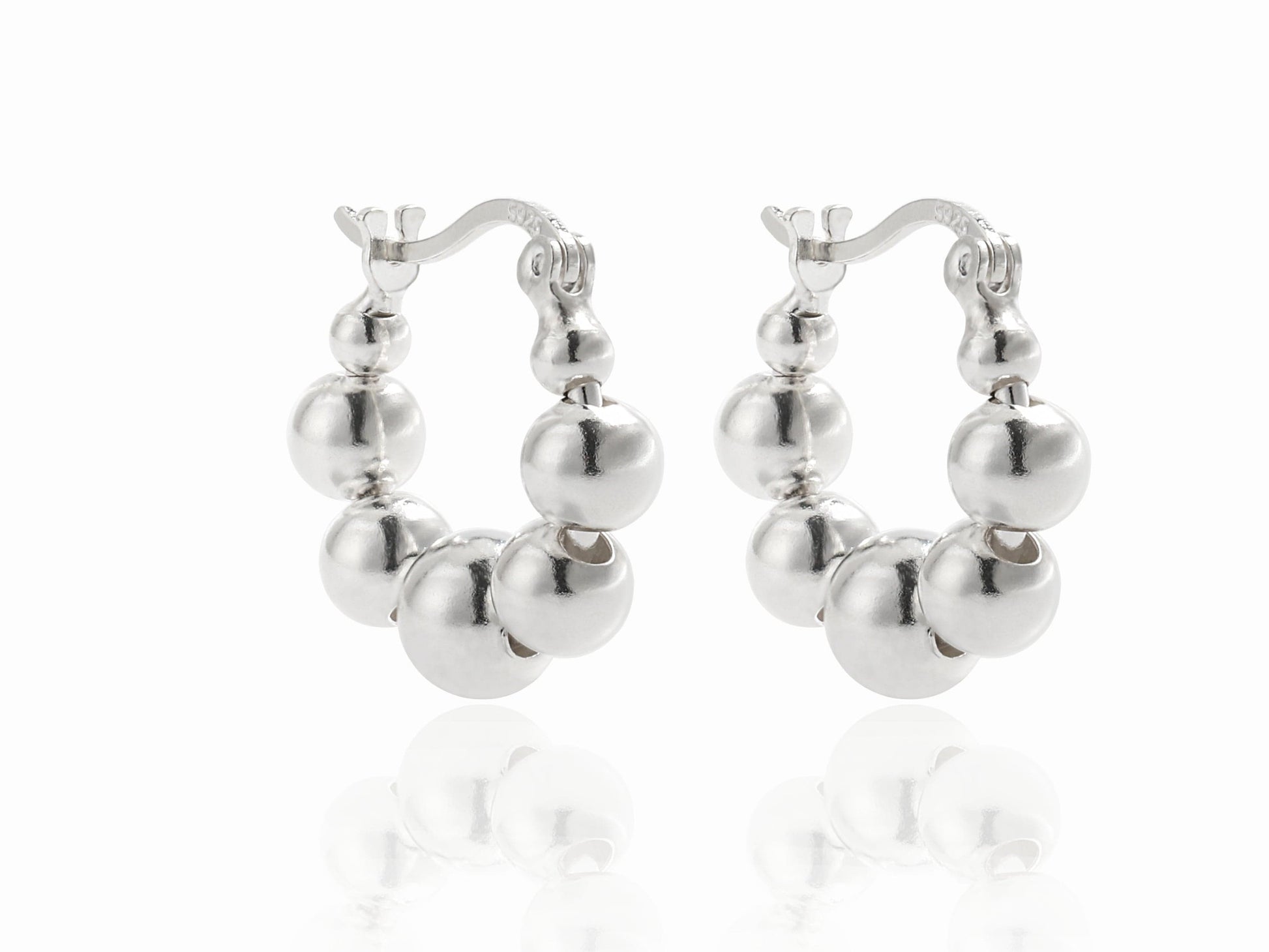 Pair of silver hoop earrings on a white background