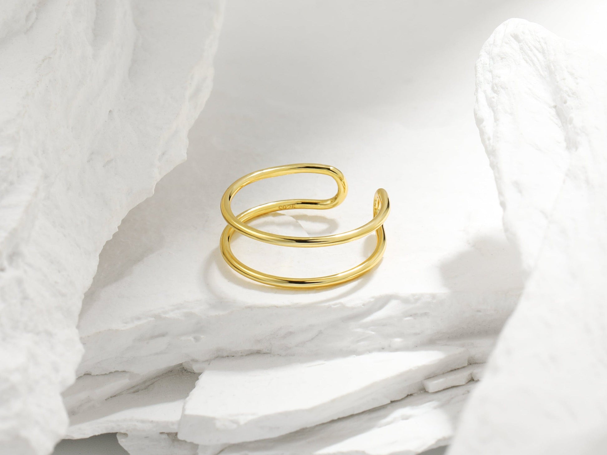 Gold ring on a white fabric background