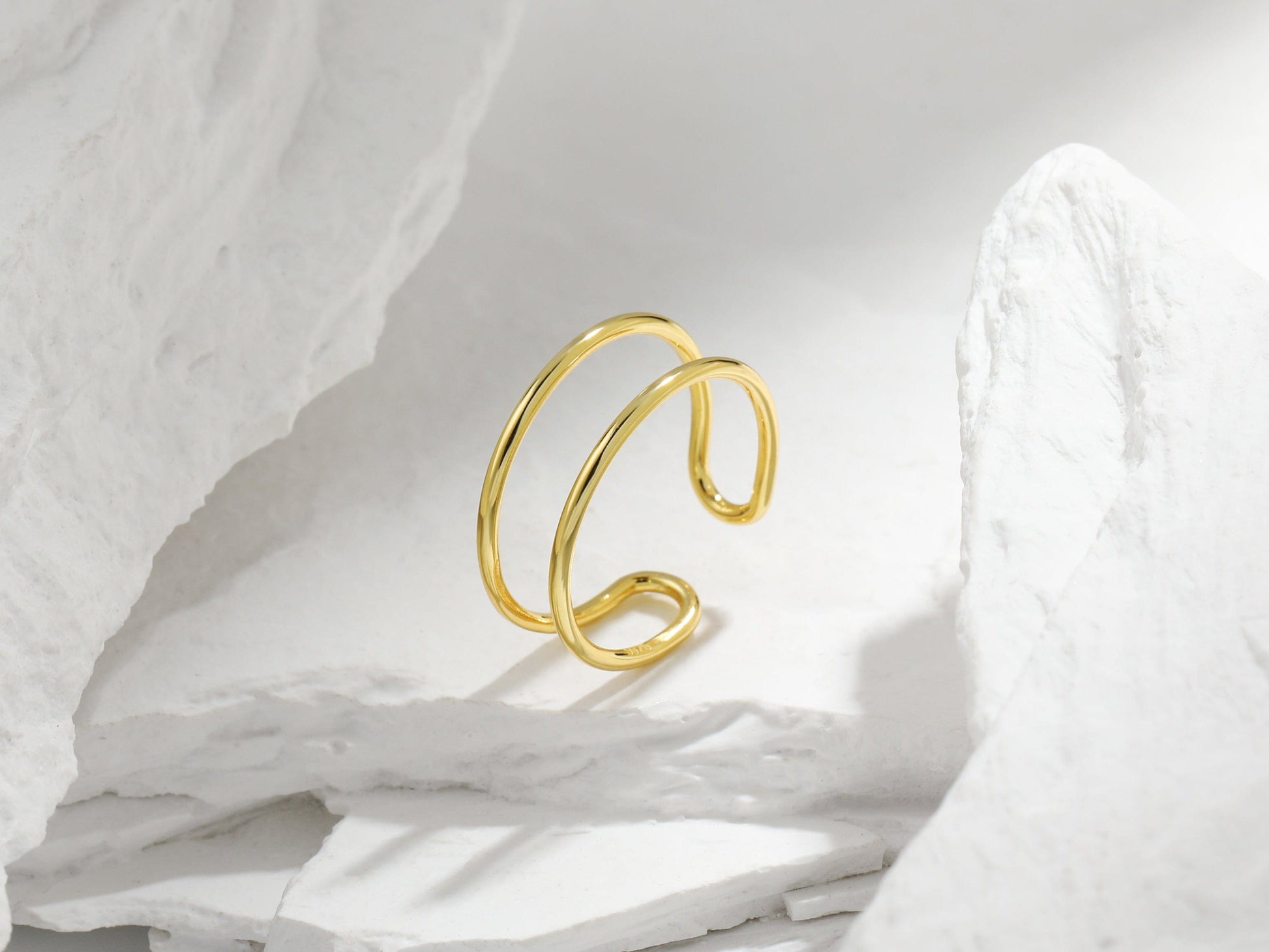 Gold ring on a white fabric background