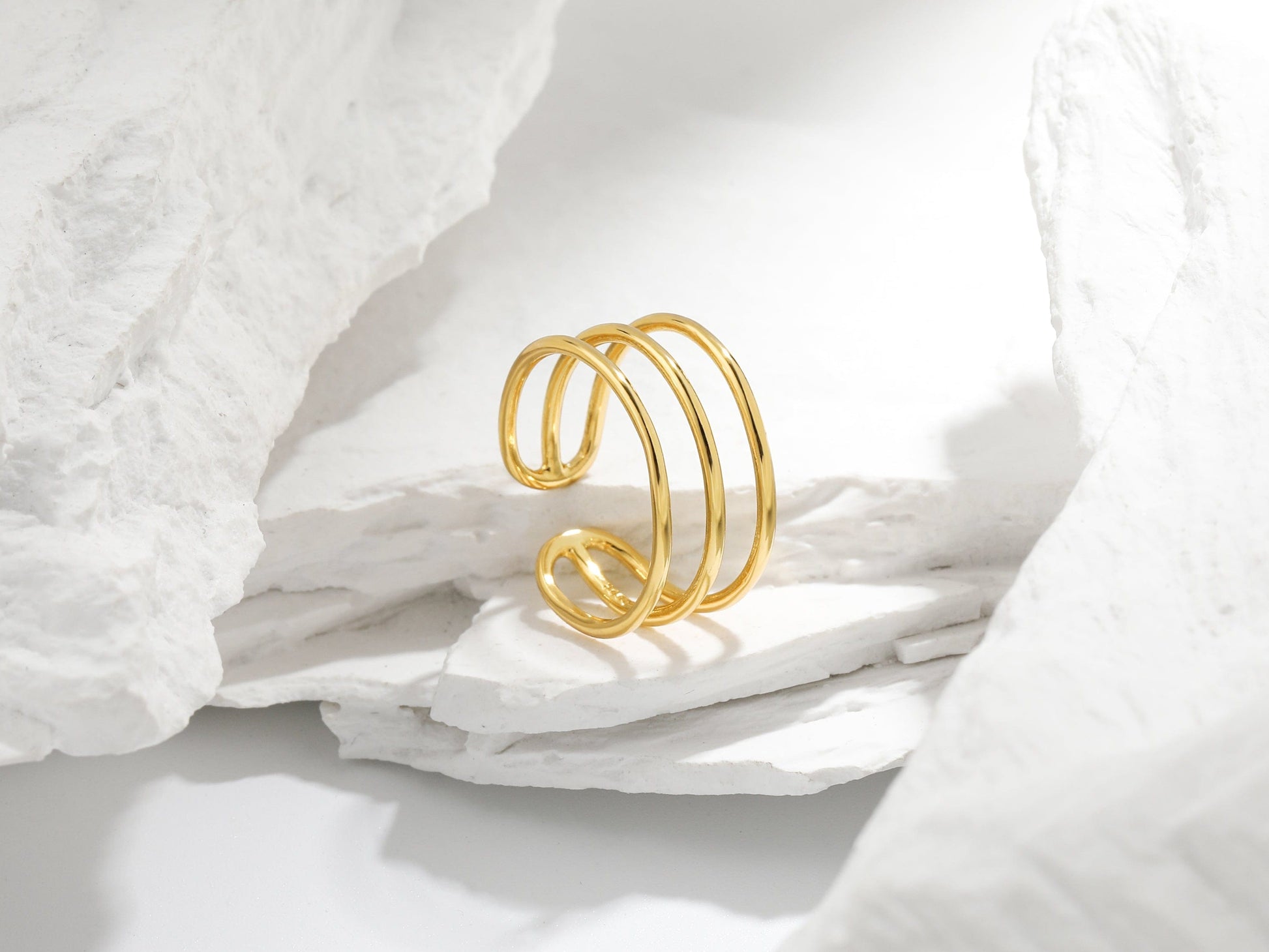 Gold ring on a white fabric background