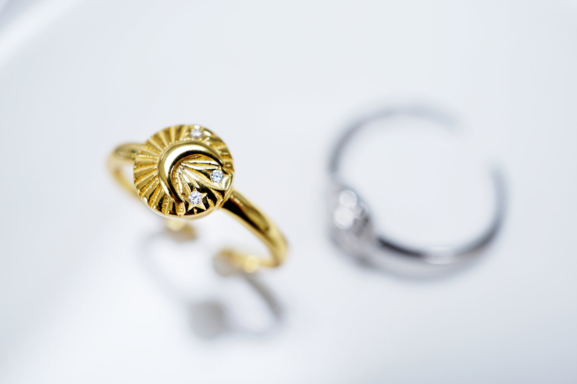 Gold ring with a diamond on a white background