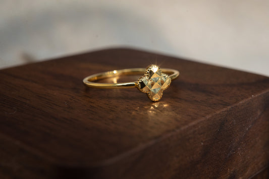 Gold ring with a large gemstone on a wooden surface