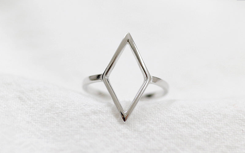 Silver geometric ring on a white background