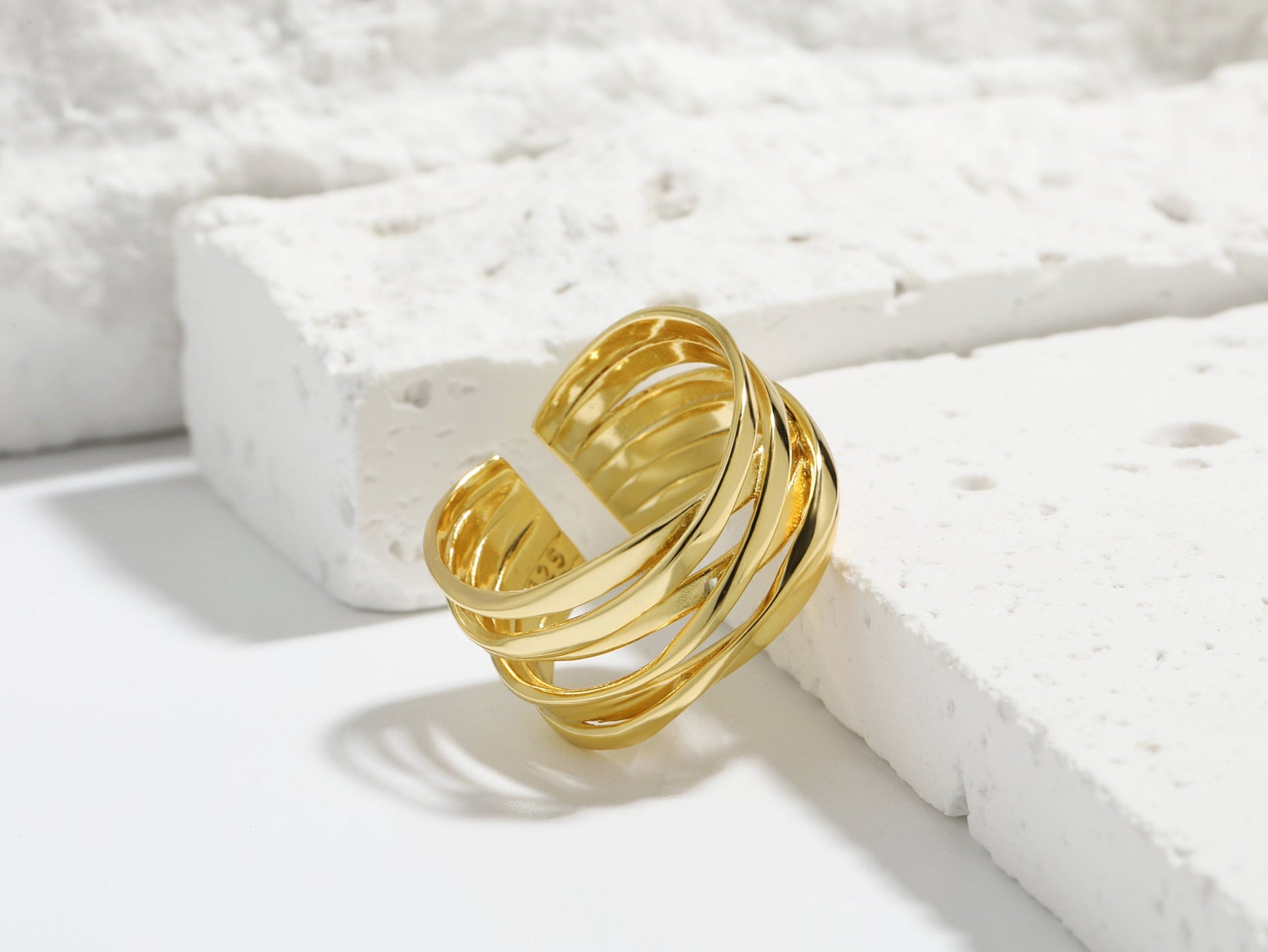 Gold ring on a textured white surface