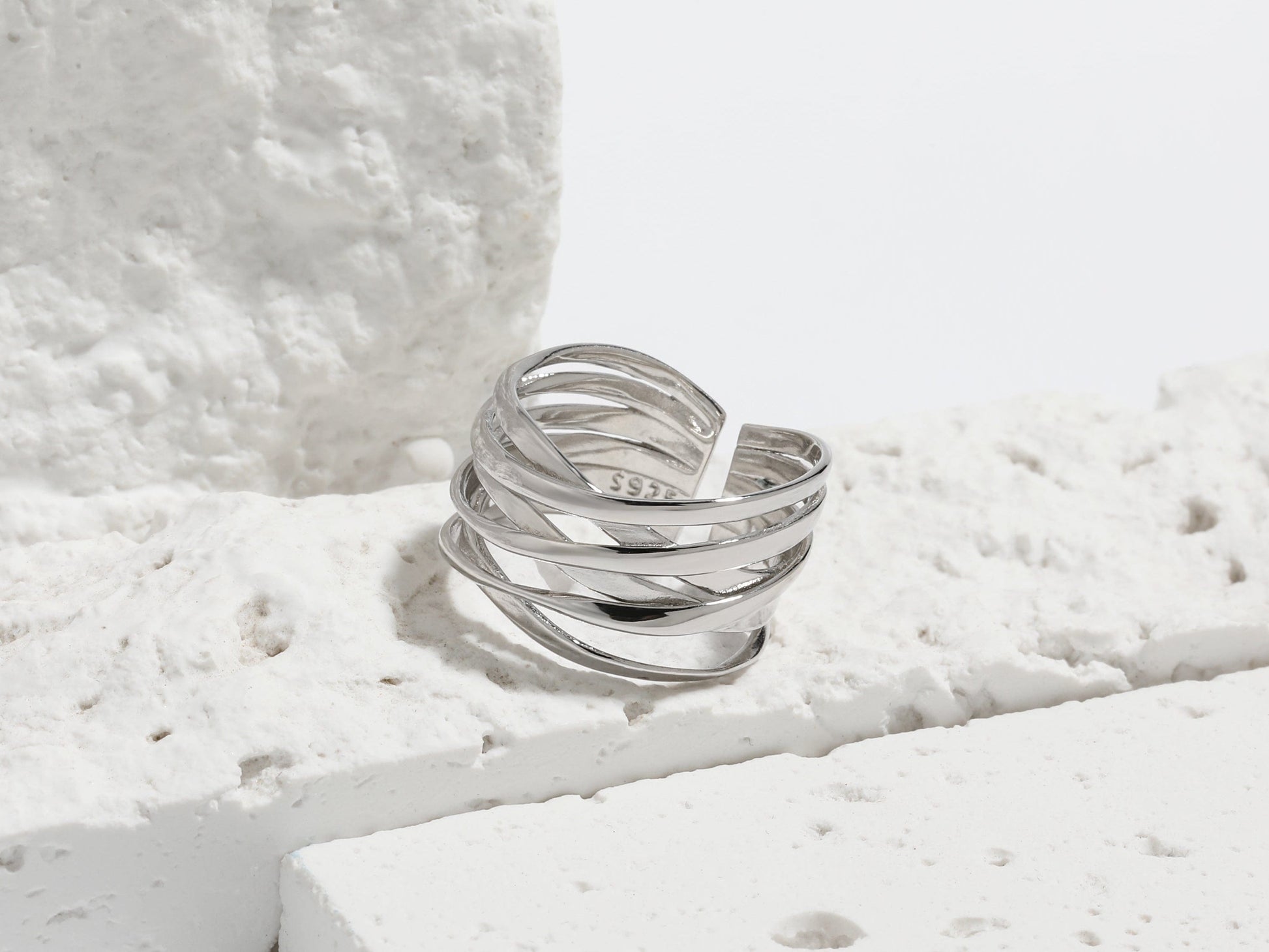 Silver ring on a textured white surface