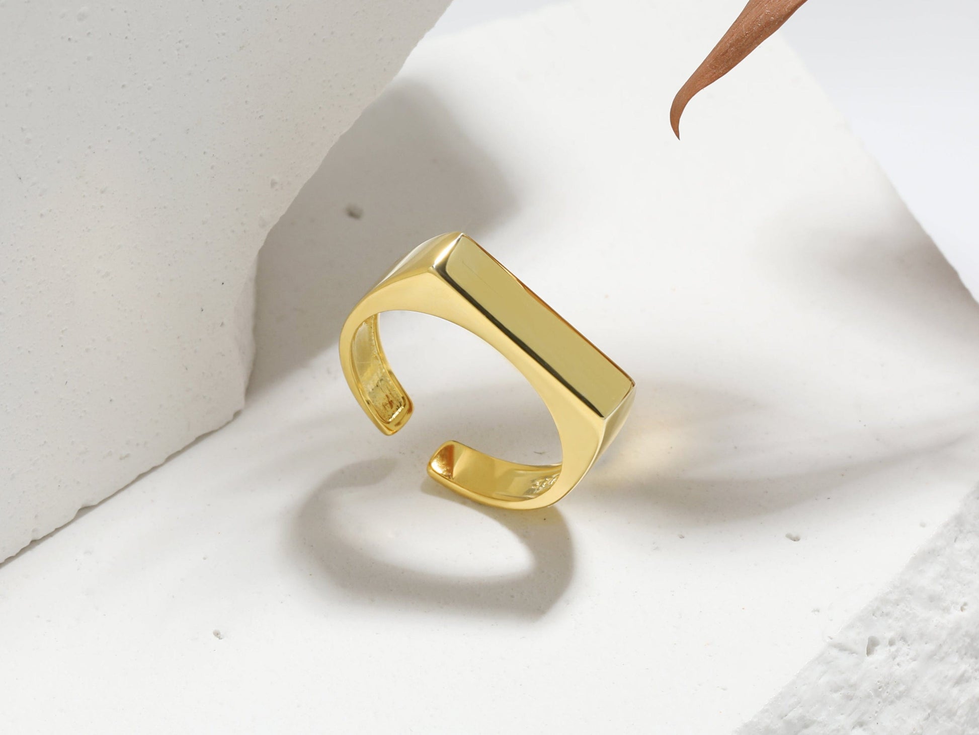 Gold ring on a white surface