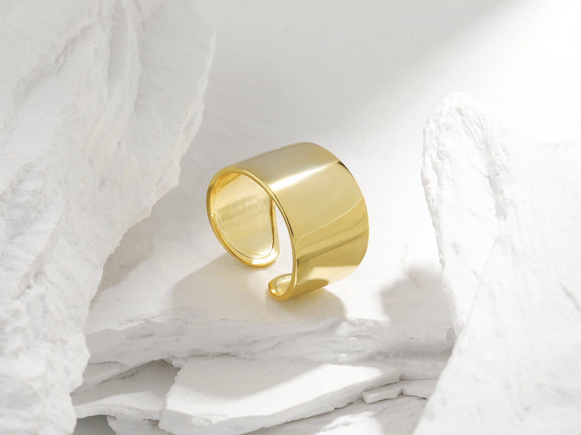 Gold ring on a textured white surface