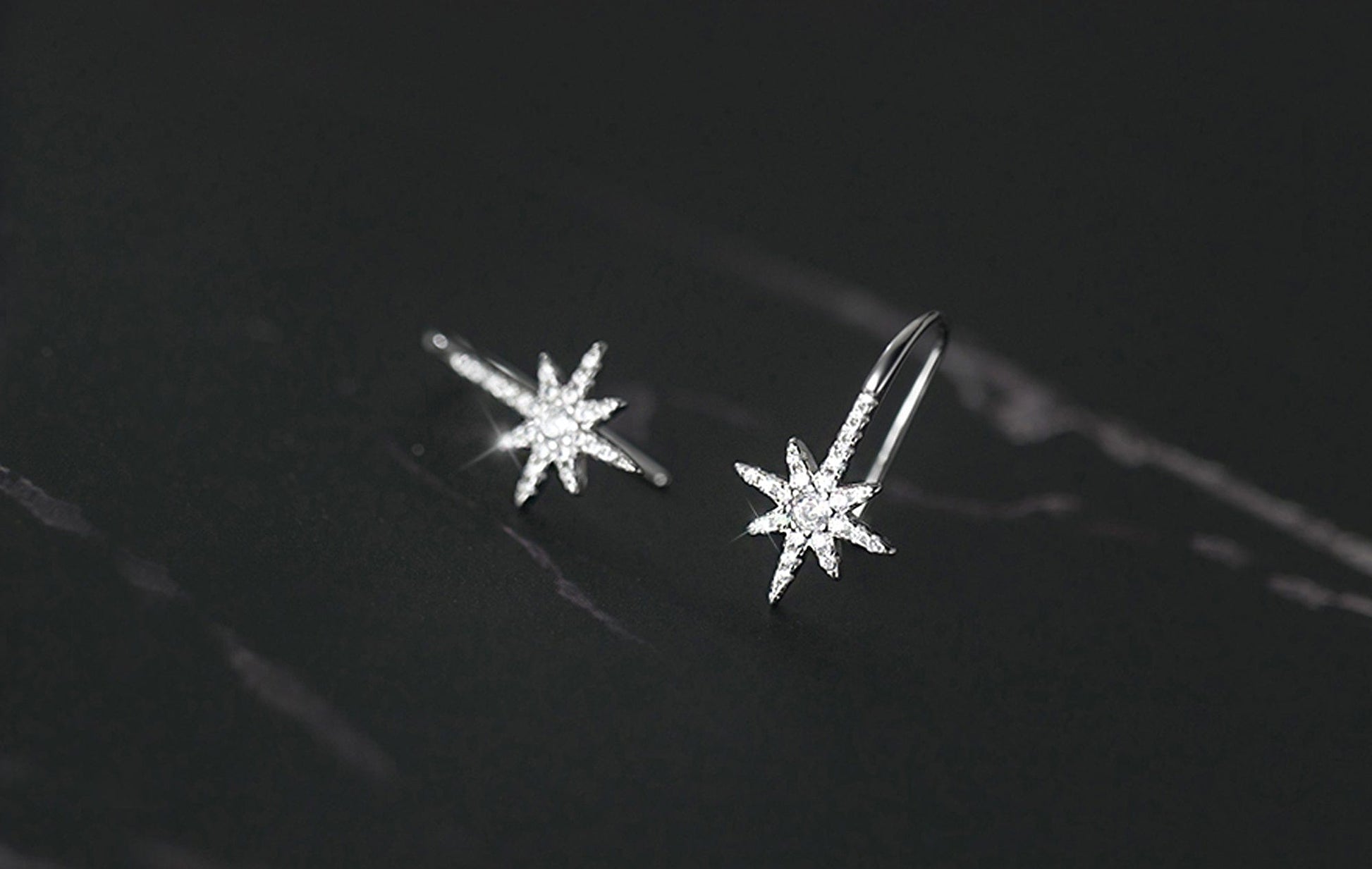 Star-shaped earrings on a dark background