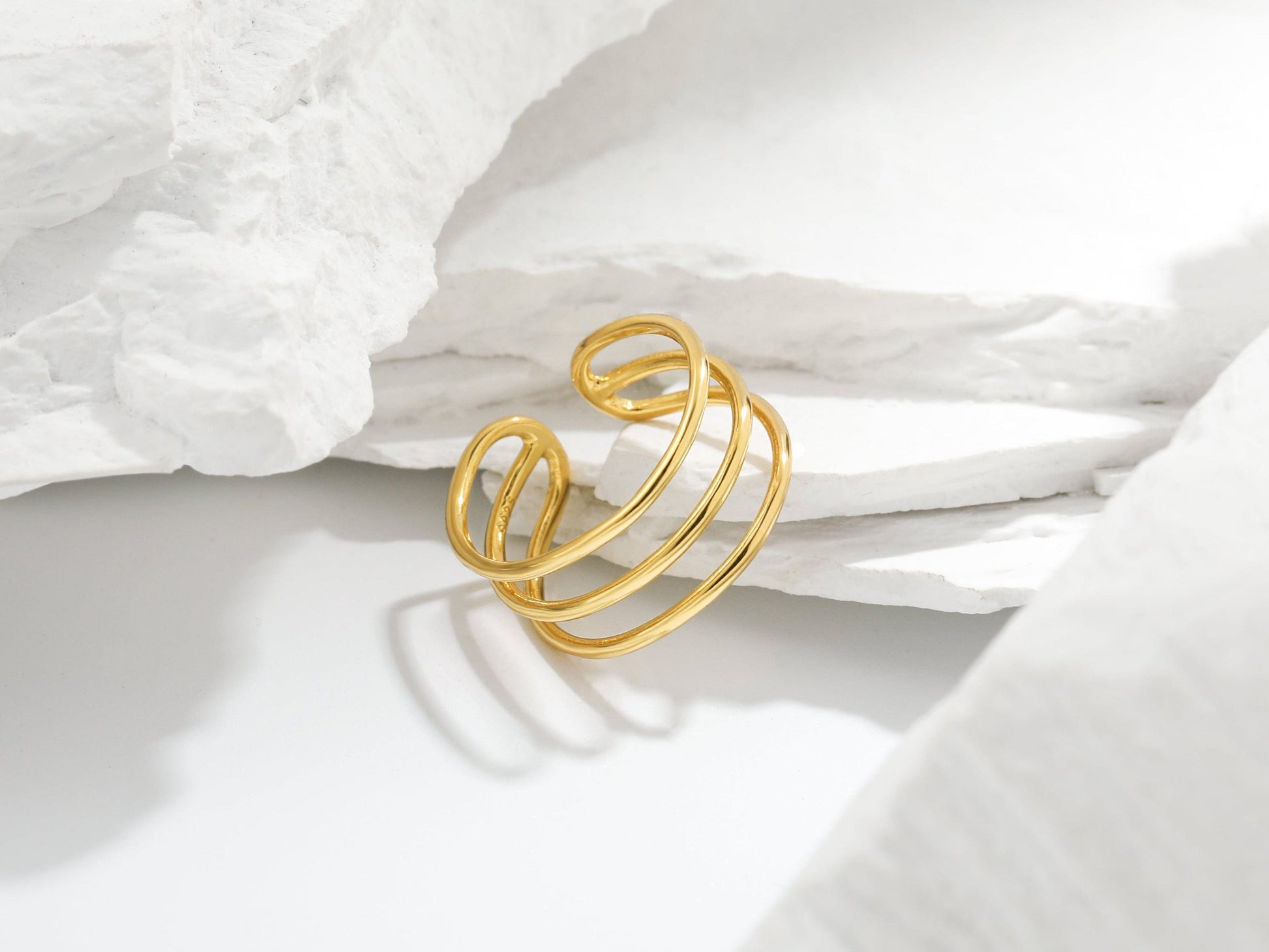 Gold ring on a white fabric background