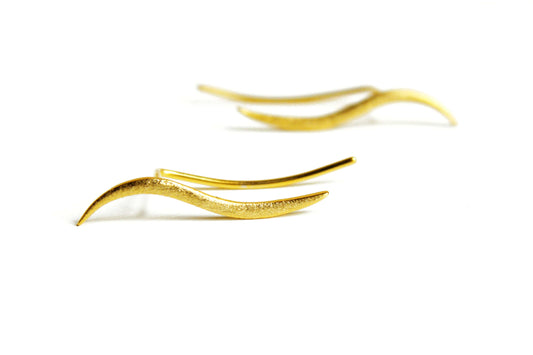 Gold earrings on a white background