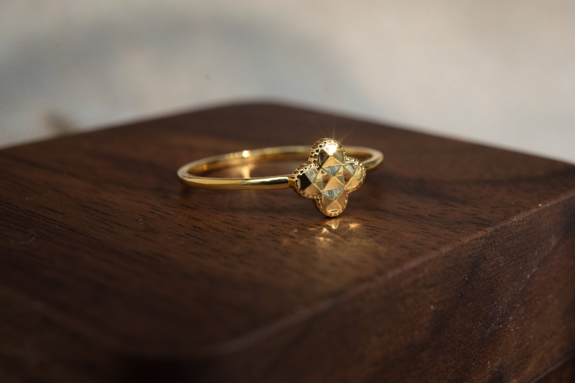 Gold ring with a large gemstone on a wooden surface