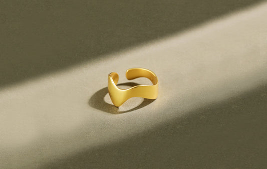Gold ring on a beige background
