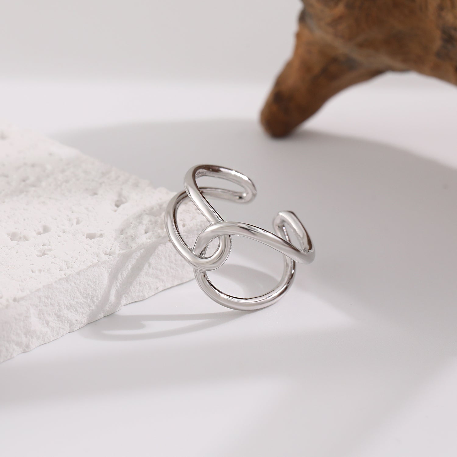 Silver ring on a white surface with a soft focus background