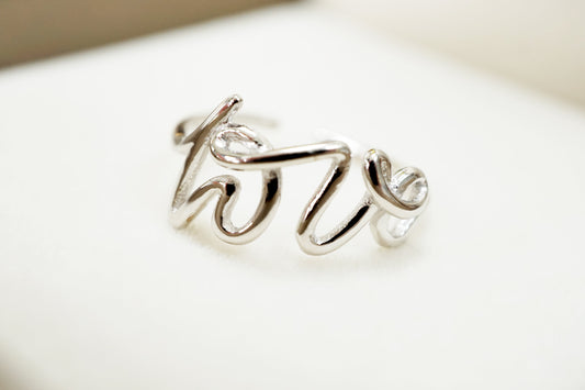 Silver ring with 'love' engraving on a light background