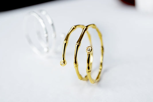Gold hoop earrings on a white surface