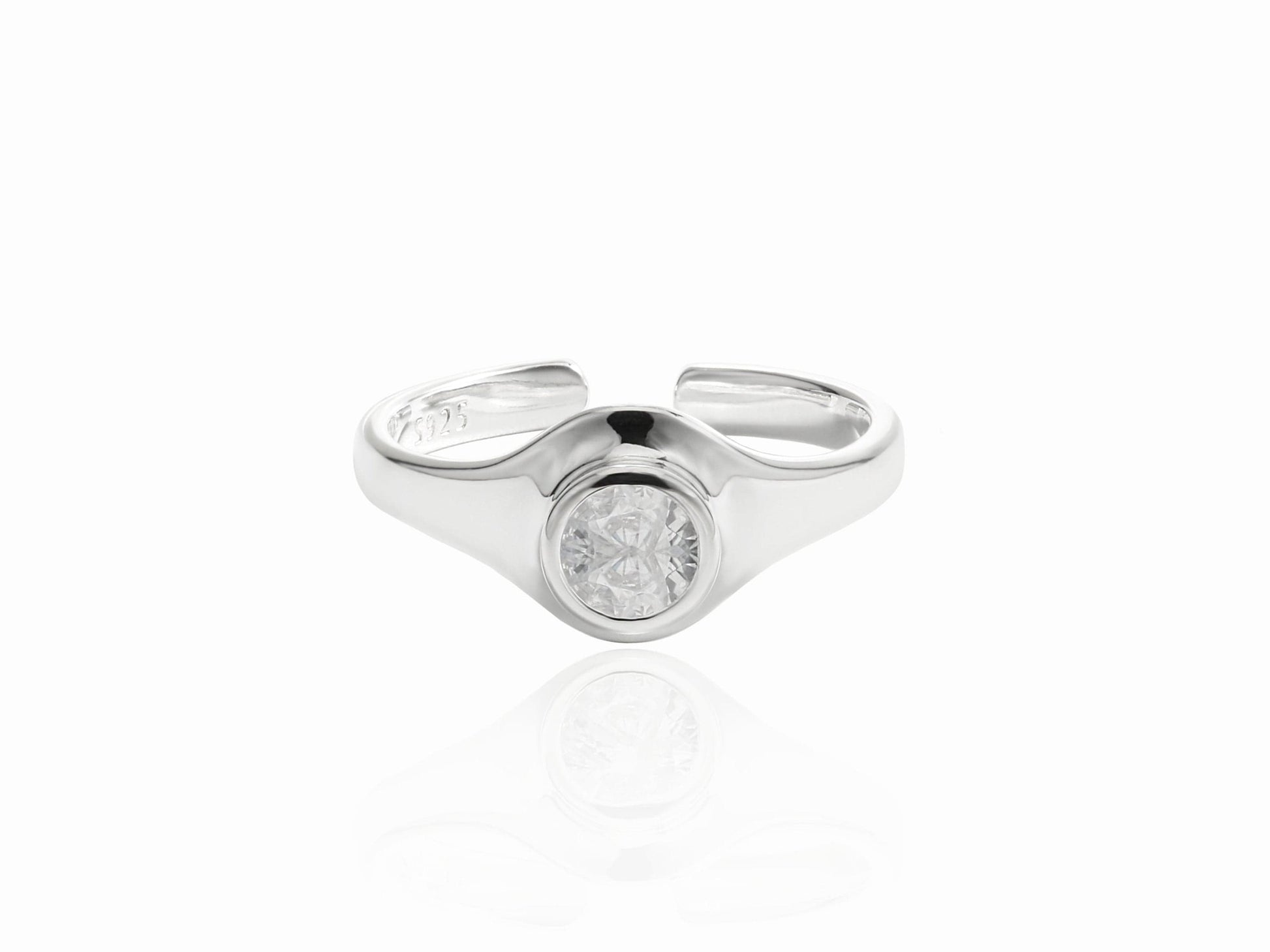 Silver ring with a diamond on a white background