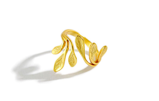 Gold leaf-shaped ring on a white background