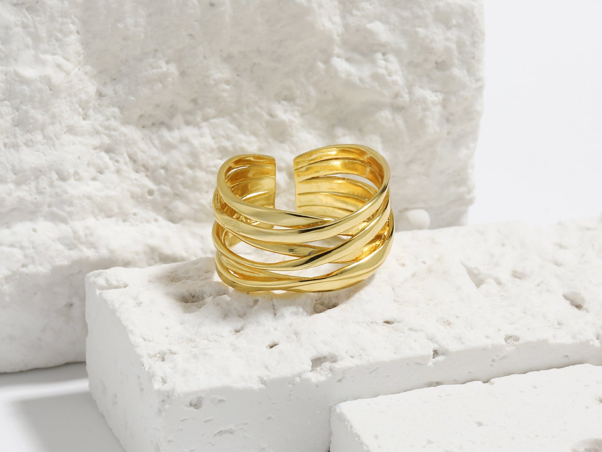 Gold ring on a textured white surface